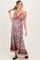 woman wearing a floral maternity maxi dress with a twisted front design and a visible baby bump