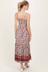 woman wearing a floral print maxi dress with smocked back and adjustable straps, viewed from the back