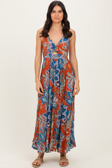 woman wearing a vibrant floral maxi dress with a deep v-neckline and spaghetti straps