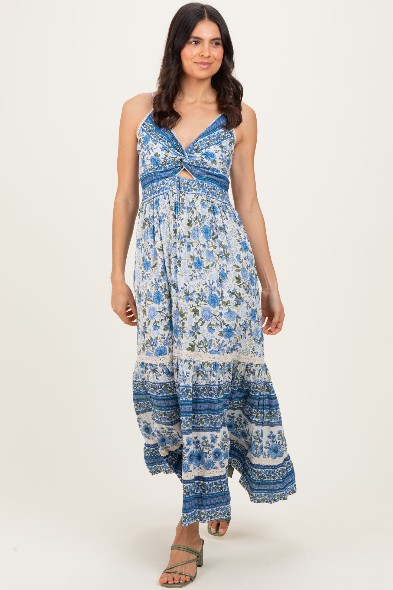 woman wearing a floral maxi dress with a blue and white pattern and a crisscross front detail