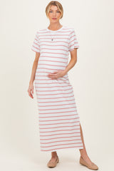 woman wearing a white and pink striped maternity maxi dress and holding her baby bump