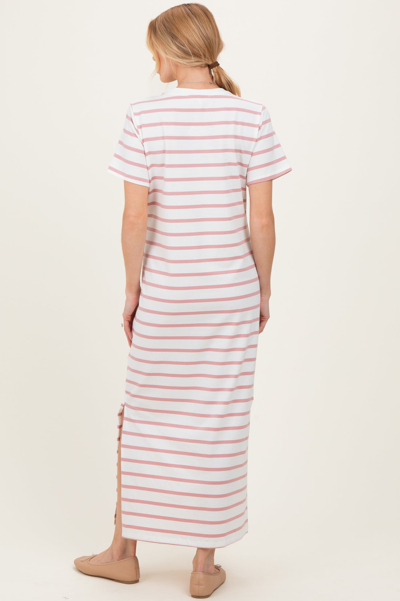 woman wearing a striped maternity maxi dress with short sleeves and side split viewed from the back