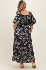 woman wearing a dark floral maternity maxi dress with puff sleeves, showing her back and long skirt