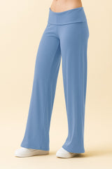 woman wearing light blue wide leg pants with a high waist and a relaxed fit