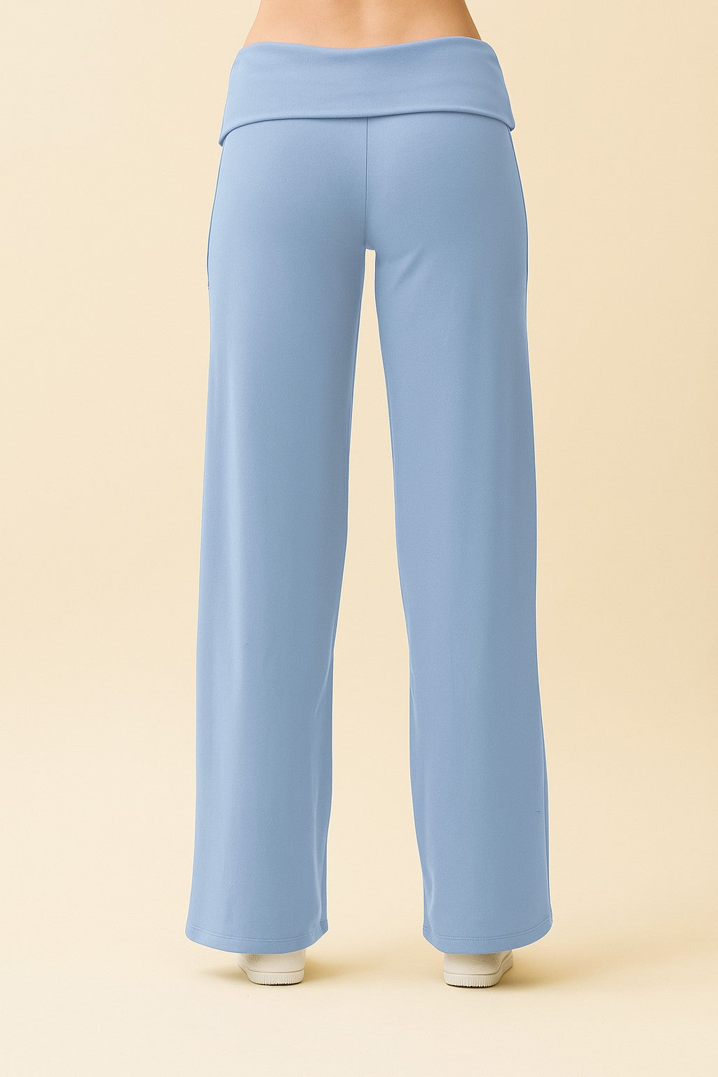 woman wearing light blue wide-leg lounge pants with a foldover waistband from the back
