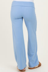 woman wearing light blue maternity pants, showing the back view with a comfortable fit and wide waistband