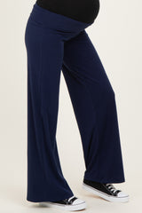 woman wearing navy blue wide-leg maternity pants with a comfortable waistband and paired with black sneakers