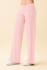 woman wearing light pink wide-leg lounge pants with an elastic waistband