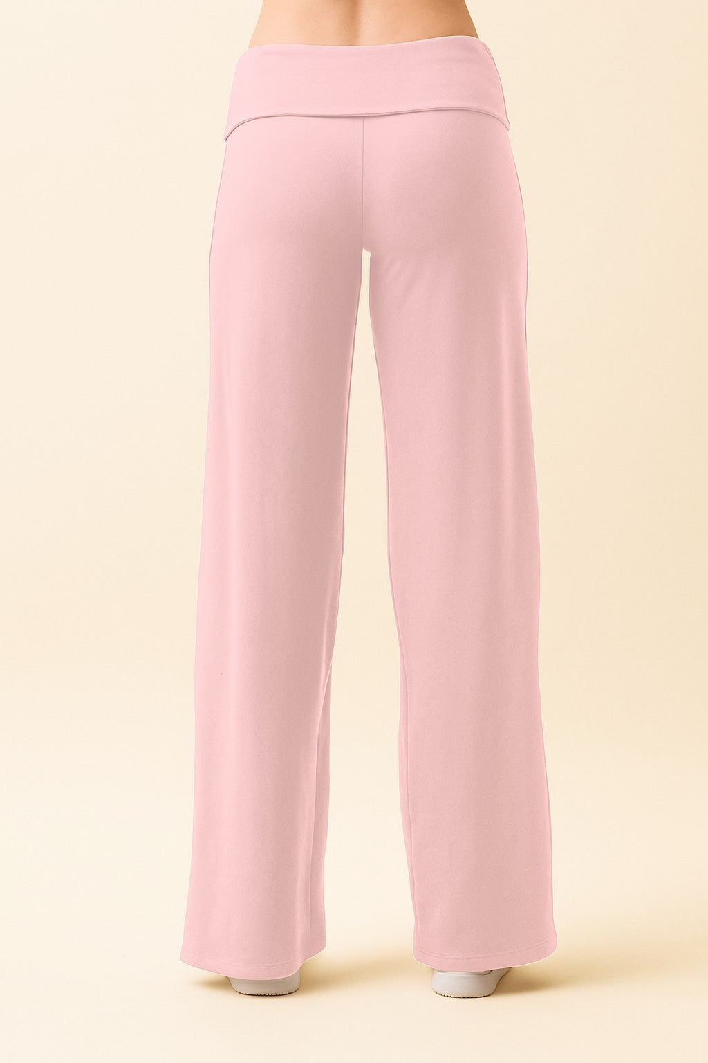 woman wearing pale pink wide-leg pants, viewed from the back