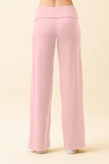 woman wearing pale pink wide-leg pants, viewed from the back