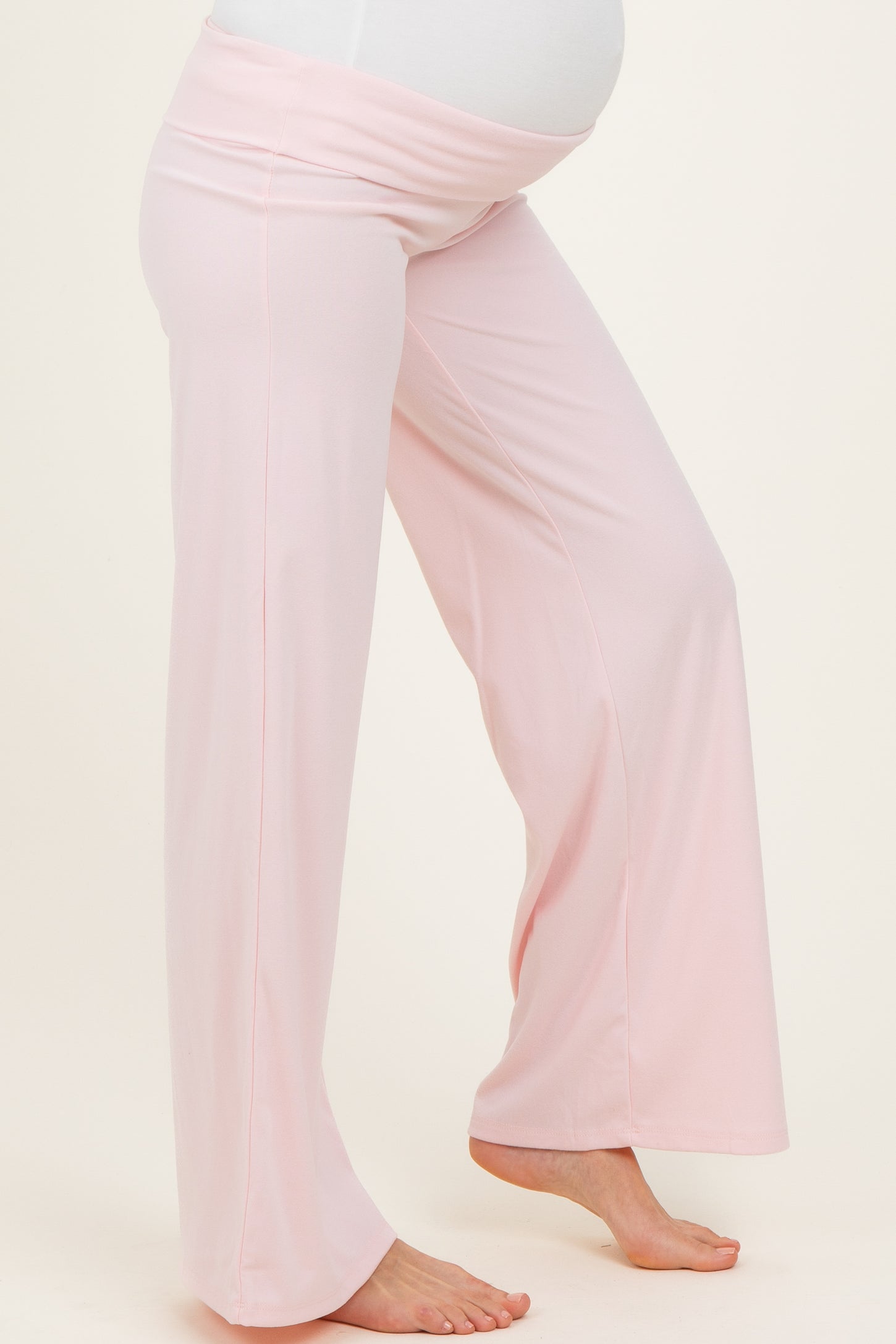 maternity wear light pink wide-leg maternity pants with a stretchy waistband and a visible baby bump