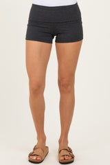 woman wearing black athletic shorts with a high waistband and standing in sandals