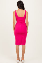 woman wearing a hot pink sleeveless bodycon dress with a back slit and rounded neckline