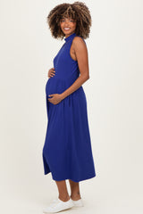 woman wearing a vibrant blue sleeveless maternity dress showing her baby bump with a smocked waist detail