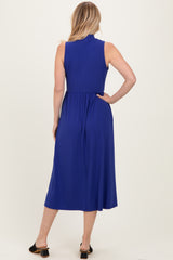 woman wearing a sleeveless royal blue midi dress with a cinched waist and a flowy skirt, viewed from the back