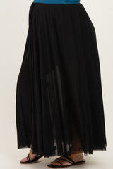 maternity wear black maxi skirt with sheer overlay and side slits, styled with a blue top and black sandals