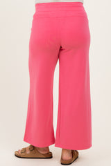 woman wearing bright pink maternity wide-leg pants, showing the back view with a relaxed fit