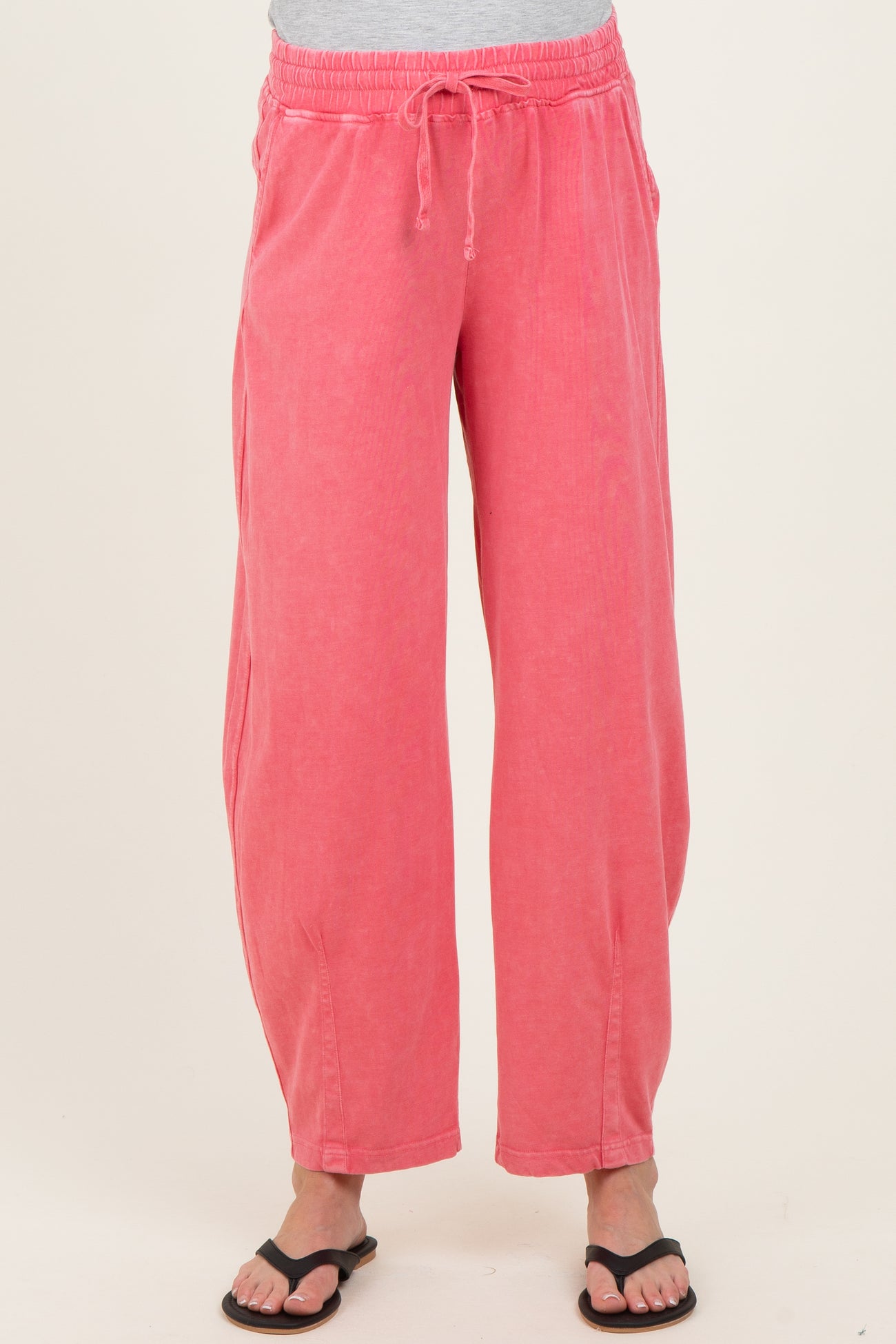woman wearing pink maternity wide-leg pants with an elastic waistband and drawstring