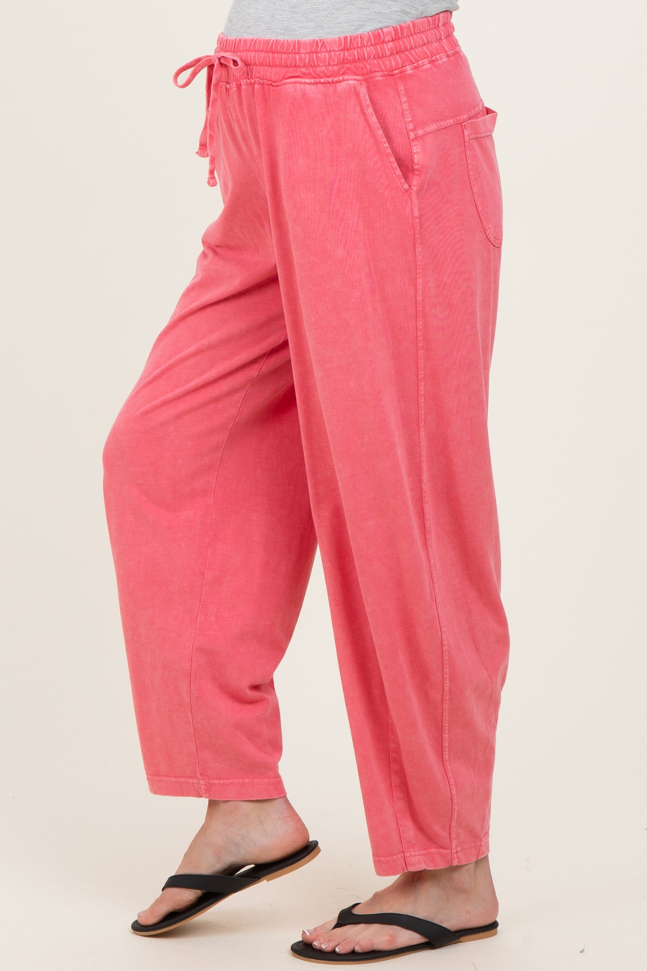 maternity wear in a soft pink color with anelastic waistband and side pockets, styled as loose-fitting pants