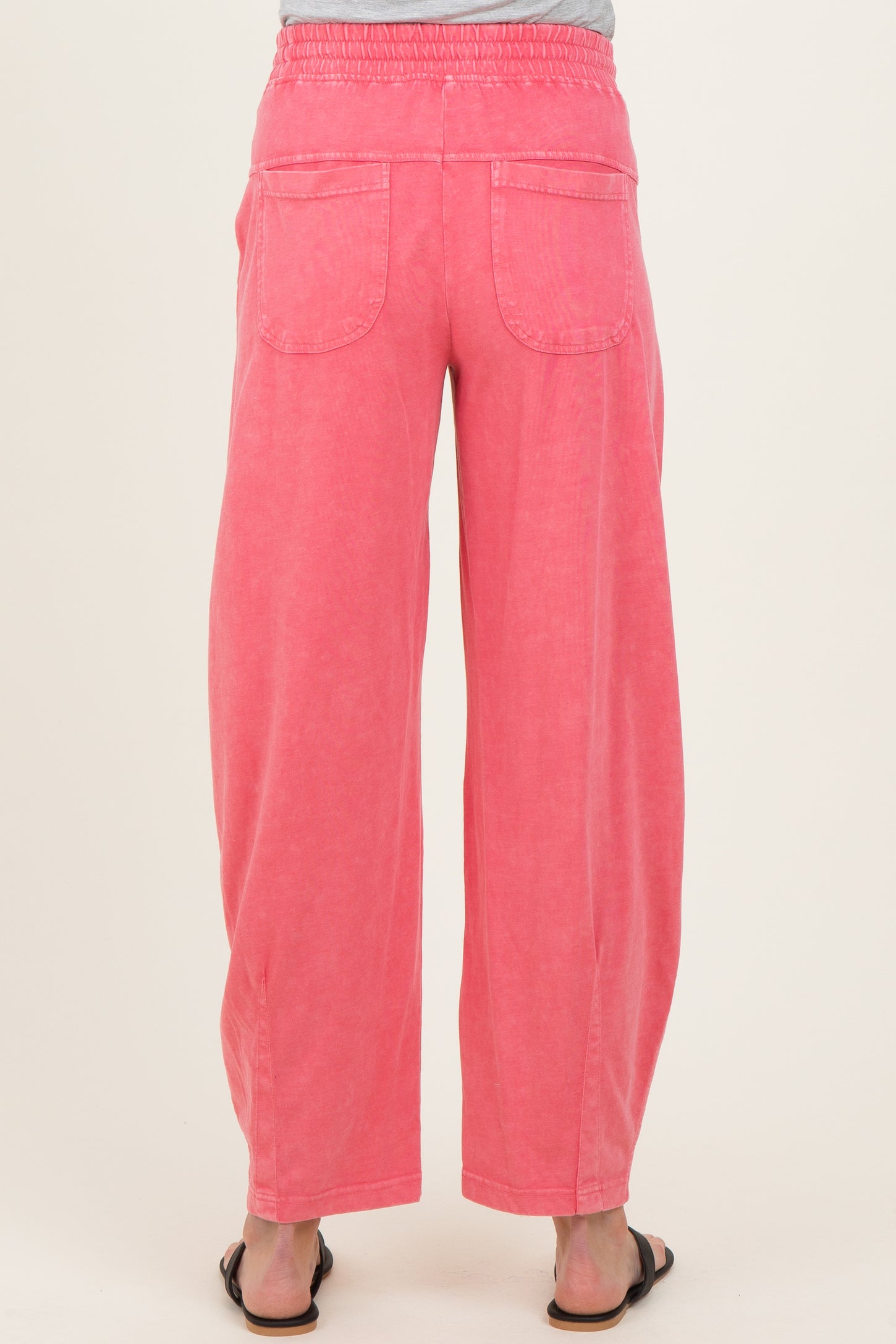 maternity wear in vibrant pink wide-leg pants with back pockets and elastic waistband, model shown from the back