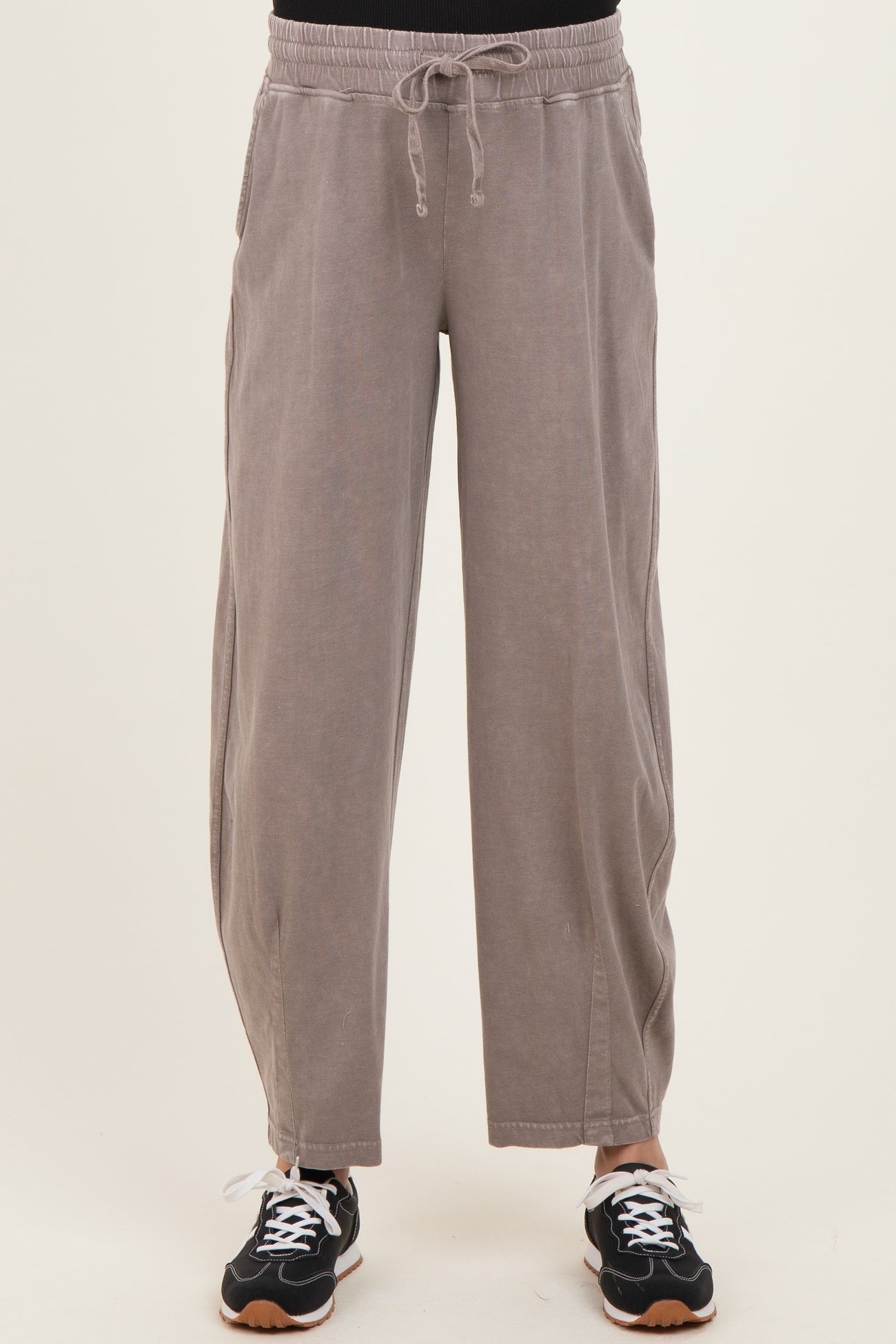maternity wear in light gray wide-leg pants with an elastic waistband and side pockets, styled with black sneakers