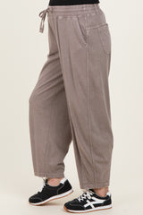 woman wearing taupe maternity jogger pants with an elastic waistband and side pockets, styled with black sneakers
