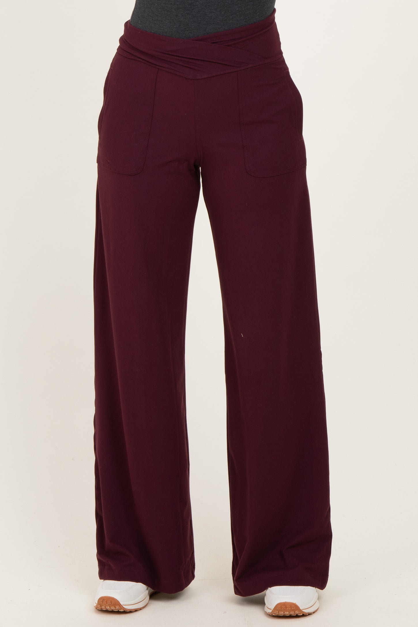 woman wearing burgundy wide-leg pants with a high waistband and front pockets