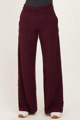 woman wearing burgundy wide-leg pants with a high waistband and front pockets