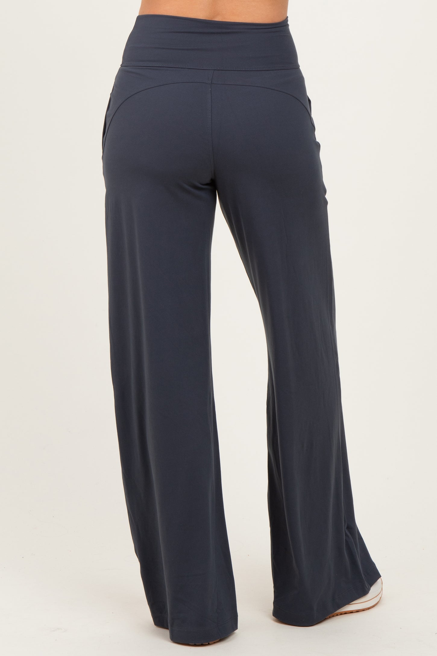 woman wearing navy blue wide-leg pants with a high waistband, viewed from the back