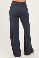 woman wearing navy blue wide-leg pants with a high waistband, viewed from the back