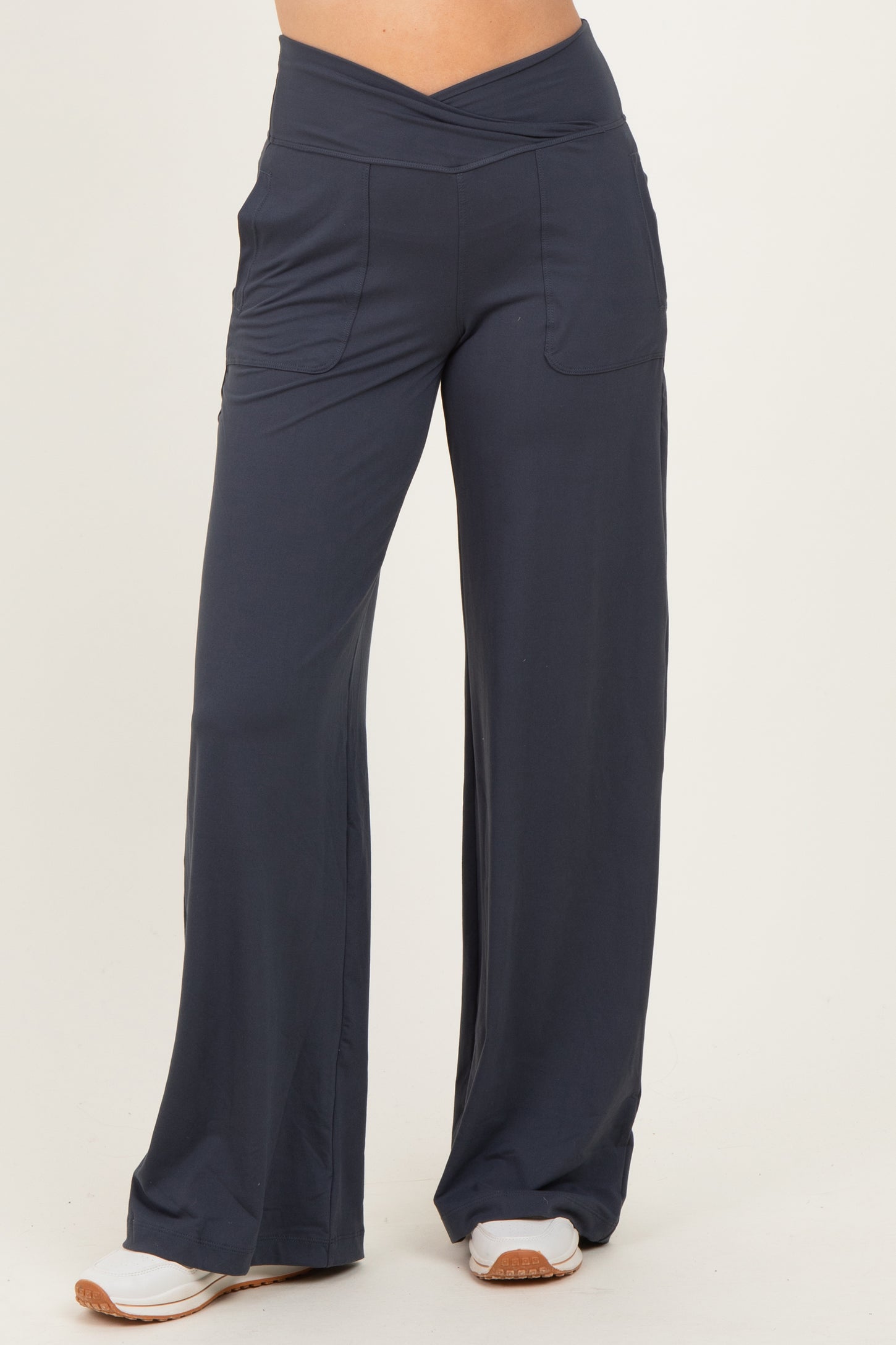 woman wearing navy blue wide-leg pants with a high waist and side pockets