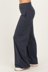 woman wearing navy wide-leg pants with a high waistband and a relaxed fit