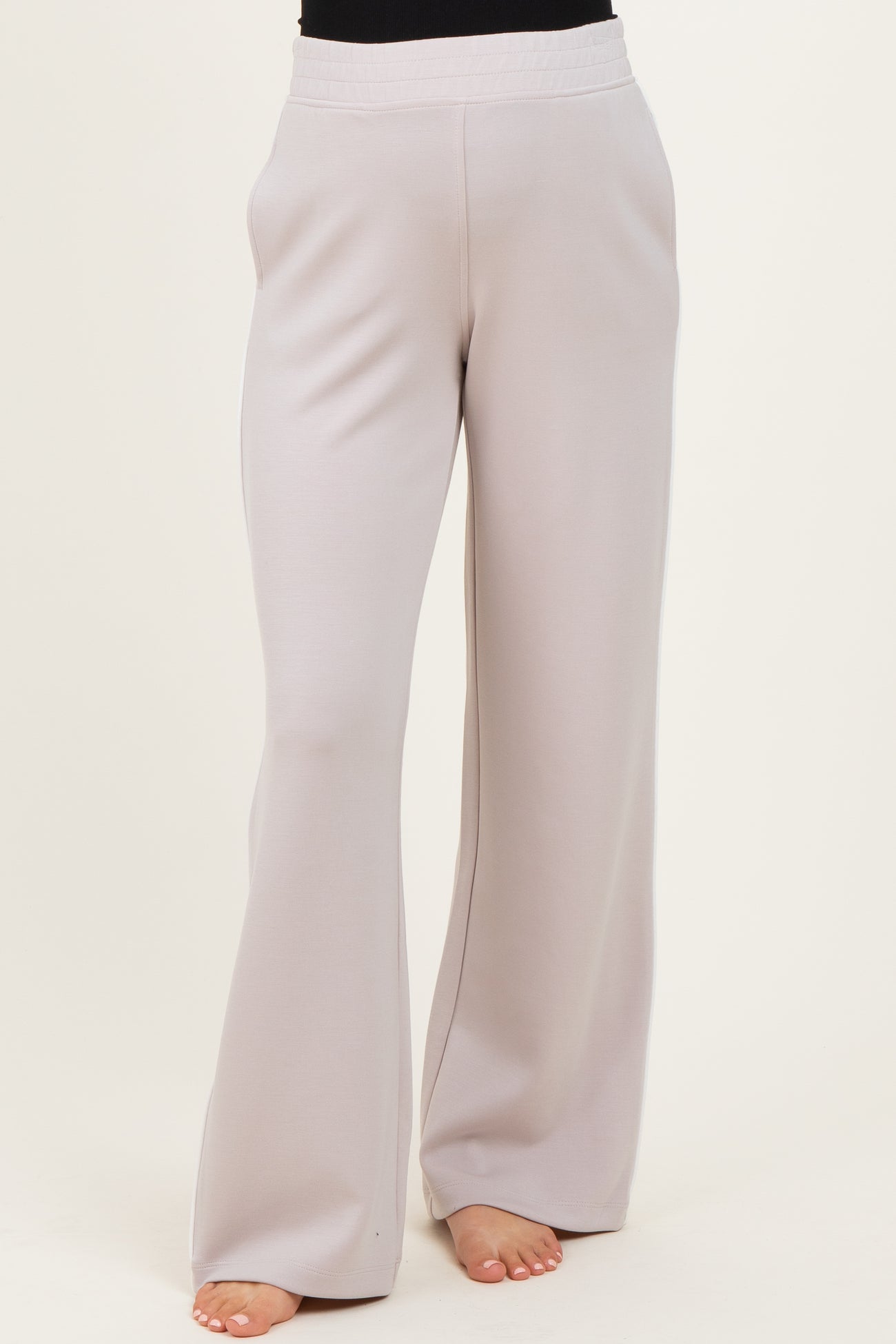 woman wearing light gray maternity wide-leg pants with an elastic waistband