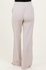 woman wearing light grey maternity pants with a relaxed fit and elastic waist from the back