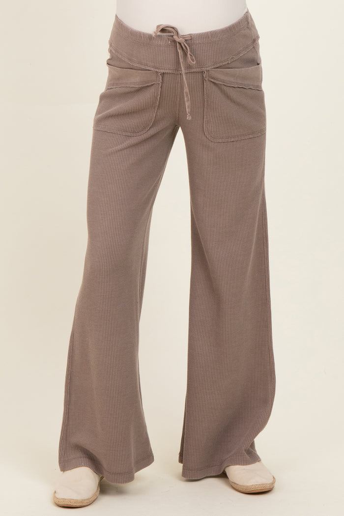 woman wearing light brown wide leg maternity pants with drawstring and front pockets