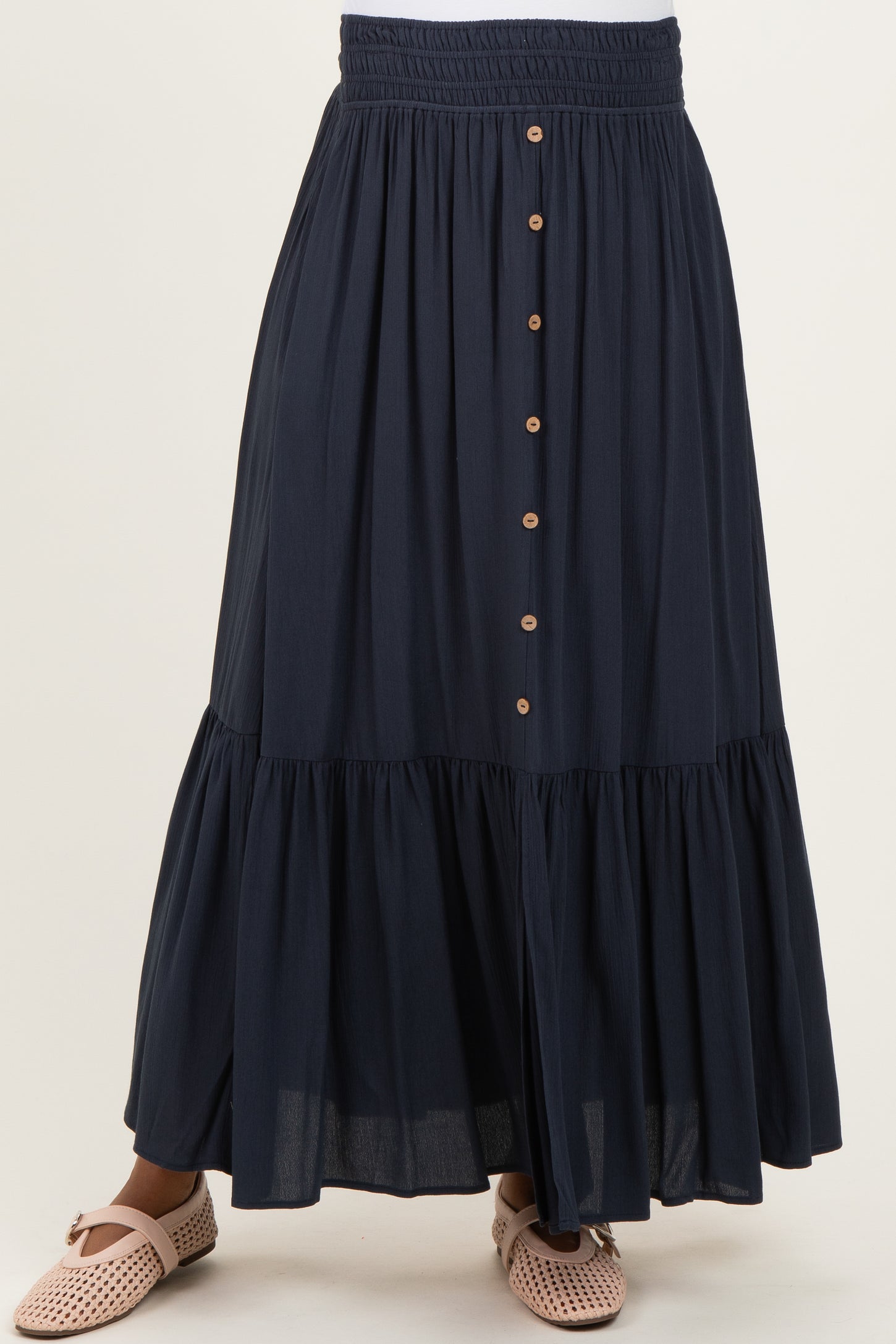 maternity wear navy blue maxi skirt with tiered design and button details, styled with casual footwear