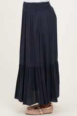 maternity wear navy blue maxi skirt with a tiered design and an elastic waistband, shown in a side view