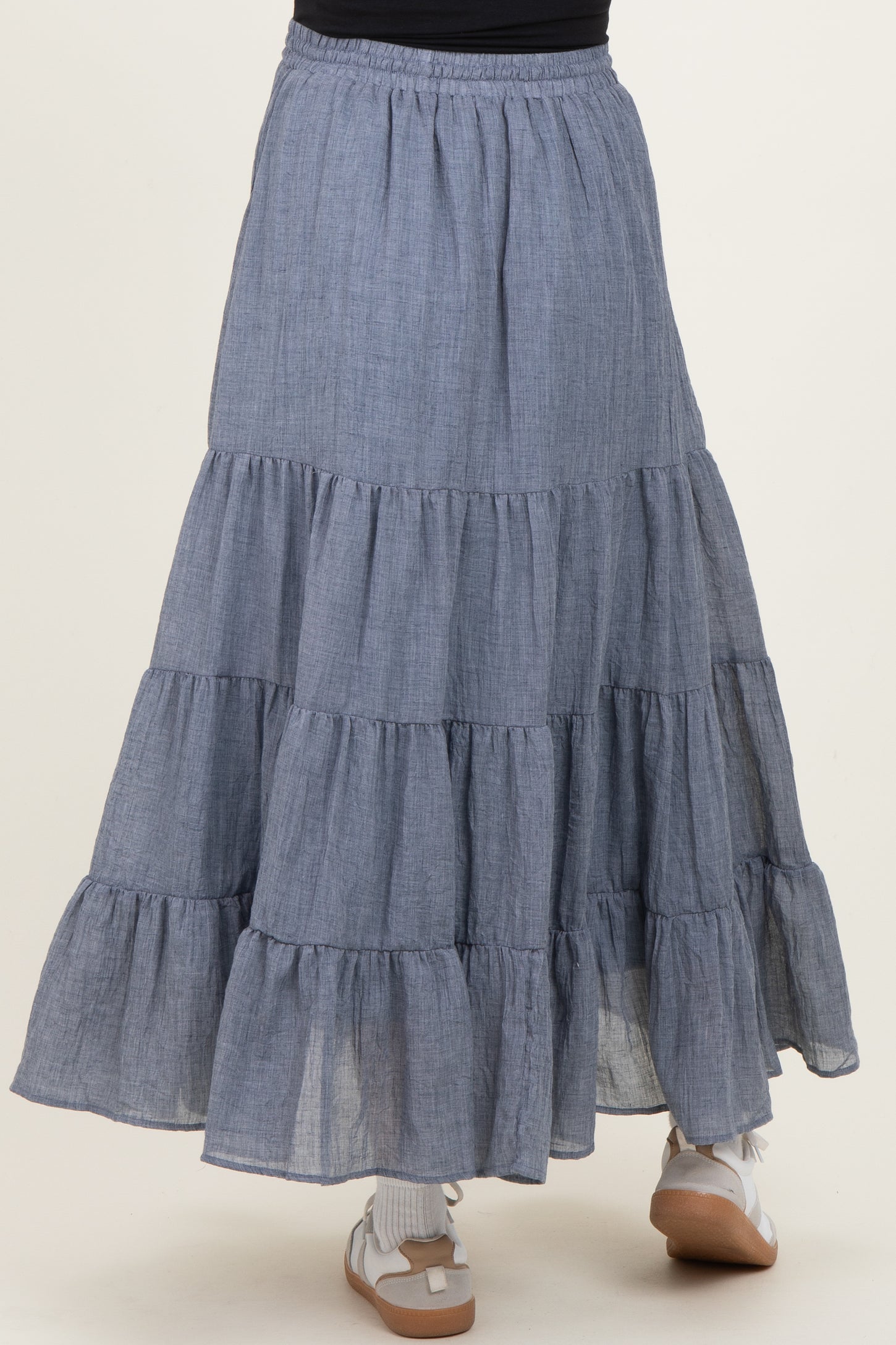 maternity wear tiered maxi skirt in a light blue chambray fabric with ruffle details and an elastic waistband