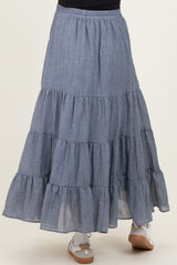 maternity wear tiered maxi skirt in a light blue chambray fabric with ruffle details and an elastic waistband
