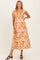 woman wearing a colorful floral print maternity maxi dress with smocked details and cap sleeves