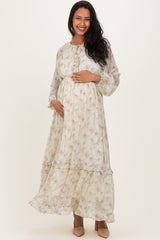 woman wearing a floral long sleeve maternity dress and displaying her baby bump