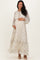 woman wearing a floral long sleeve maternity dress and displaying her baby bump