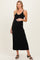 woman wearing a black ribbed maternity maxi dress with adjustable straps and showcasing her baby bump