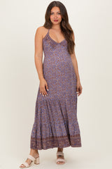 woman wearing a patterned maxi maternity dress with a v-neckline and spaghetti straps