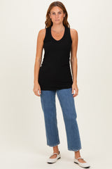 woman wearing a black ribbed sleeveless tank top and blue cropped jeans