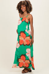 woman wearing a green floral maternity maxi dress with spaghetti straps and a visible baby bump