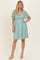 woman wearing a light teal lace short dress with flutter sleeves and a fitted bodice