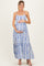 woman wearing a blue and white patterned maternity maxi dress and holding her baby bump