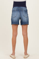 woman wearing dark blue maternity denim shorts with a stretchy waistband, view from the back