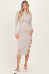 woman wearing a beige ribbed midi dress with long sleeves and side slits